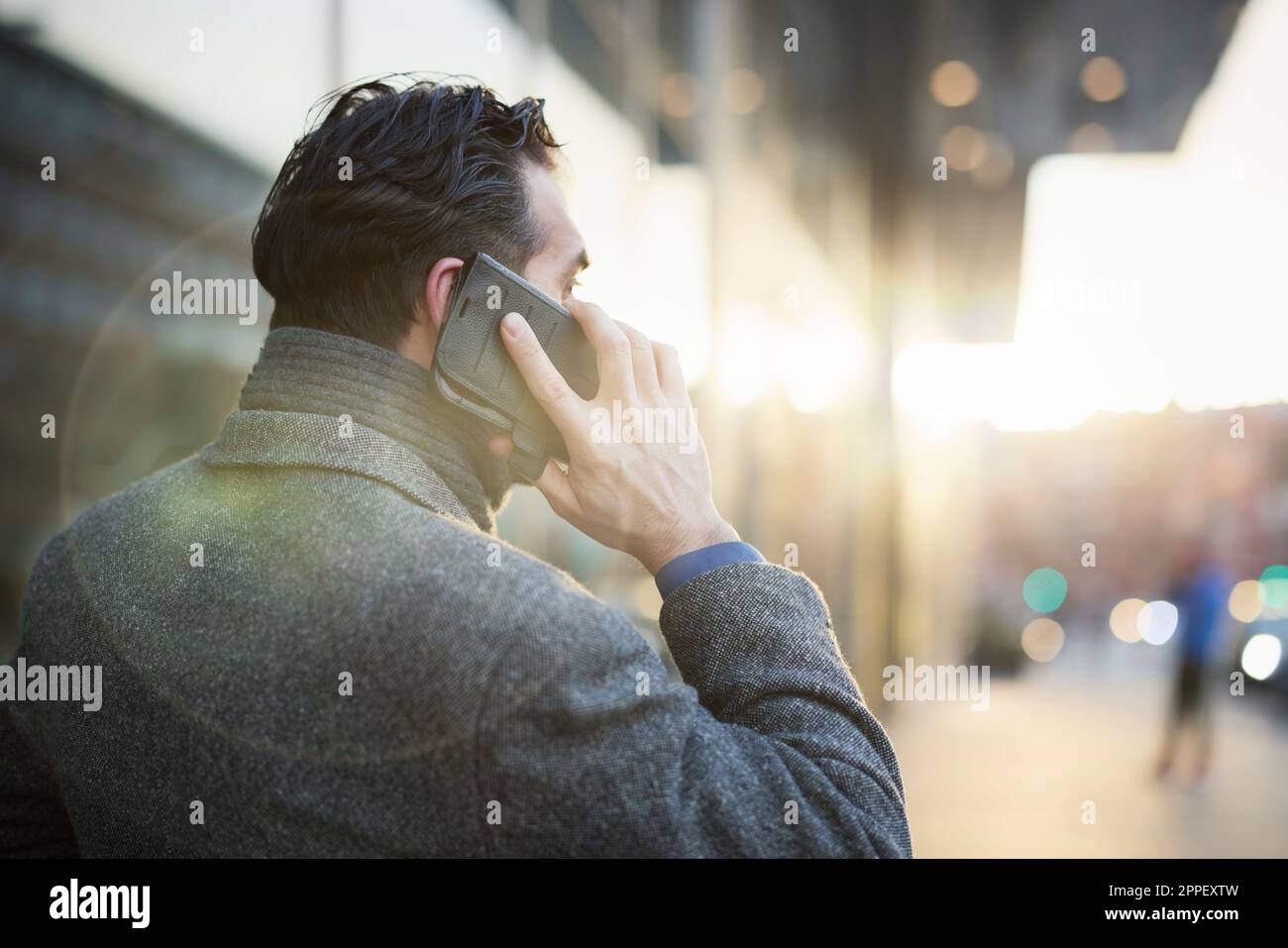 Businessman talking on phone outdoors Stock Photo