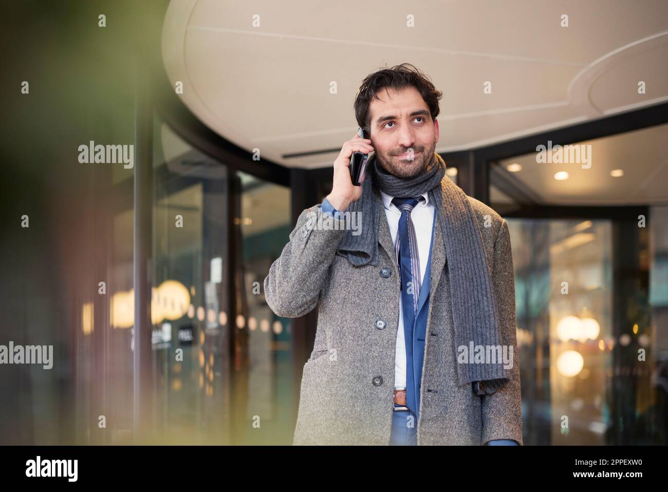 Businessman talking on phone outdoors Stock Photo