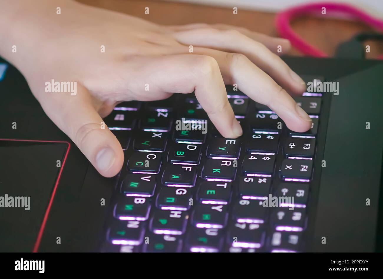 Hands of child using laptop Stock Photo