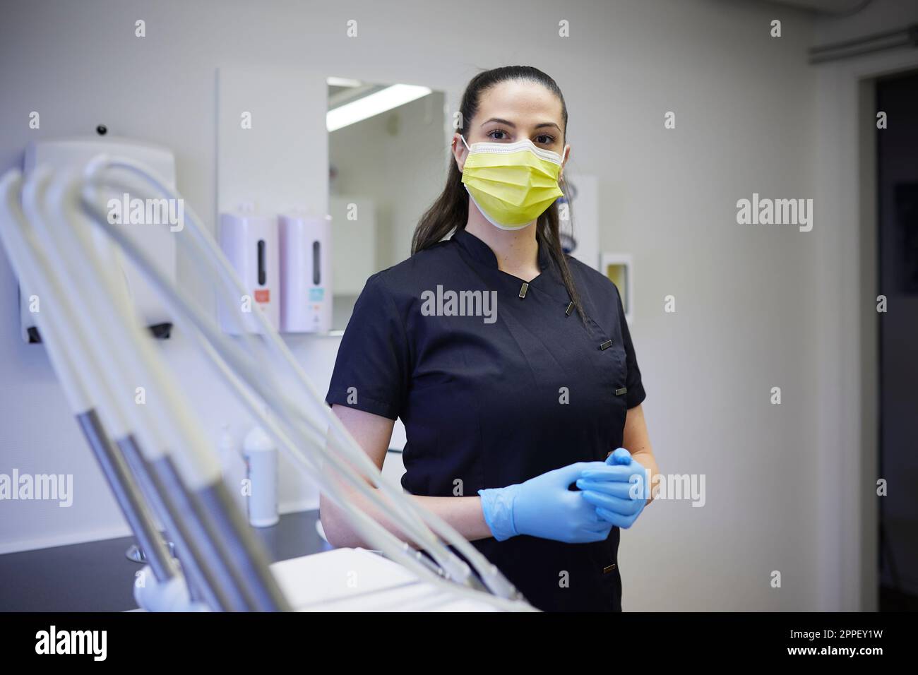 Female dentist standing in office Stock Photo