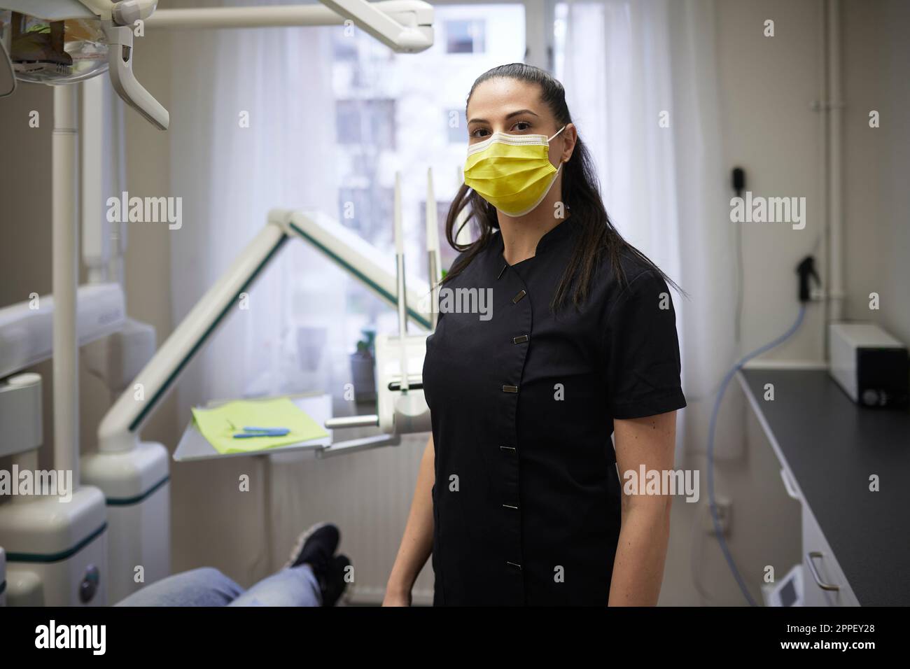 Female dentist standing in office Stock Photo