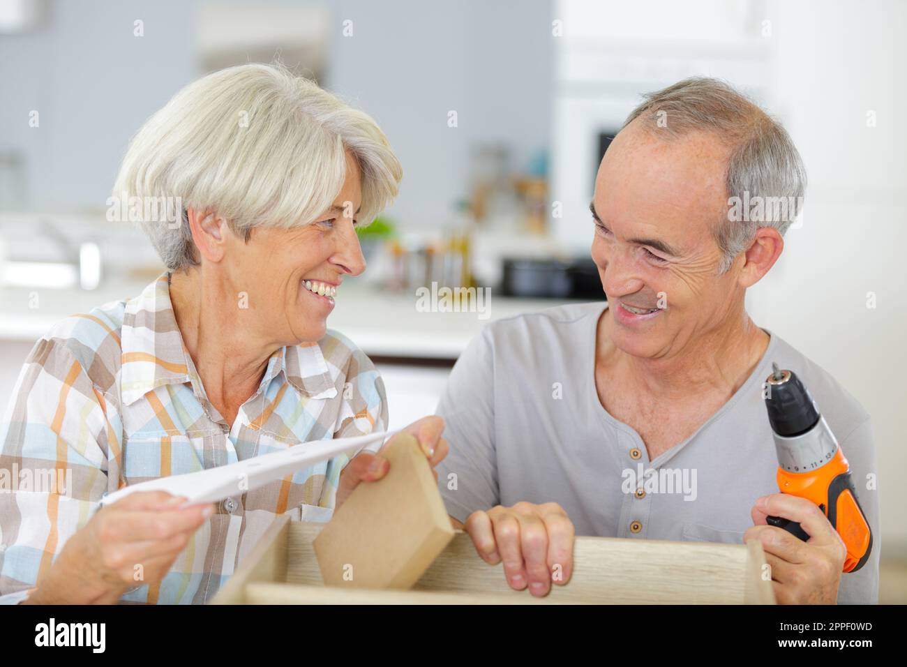 happy senior couple doing diy Stock Photo