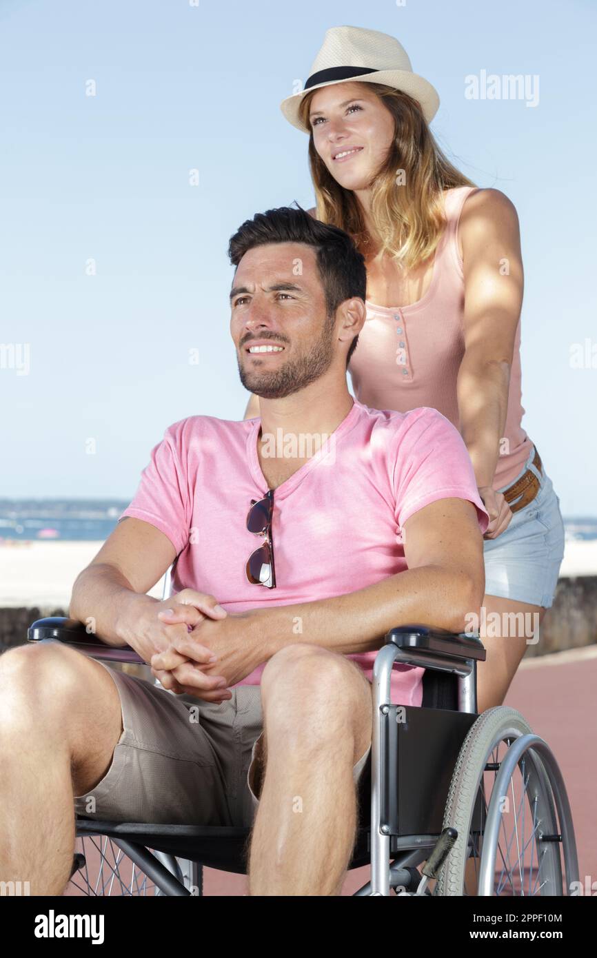 handicapped young couple resting on a beach Stock Photo Alamy