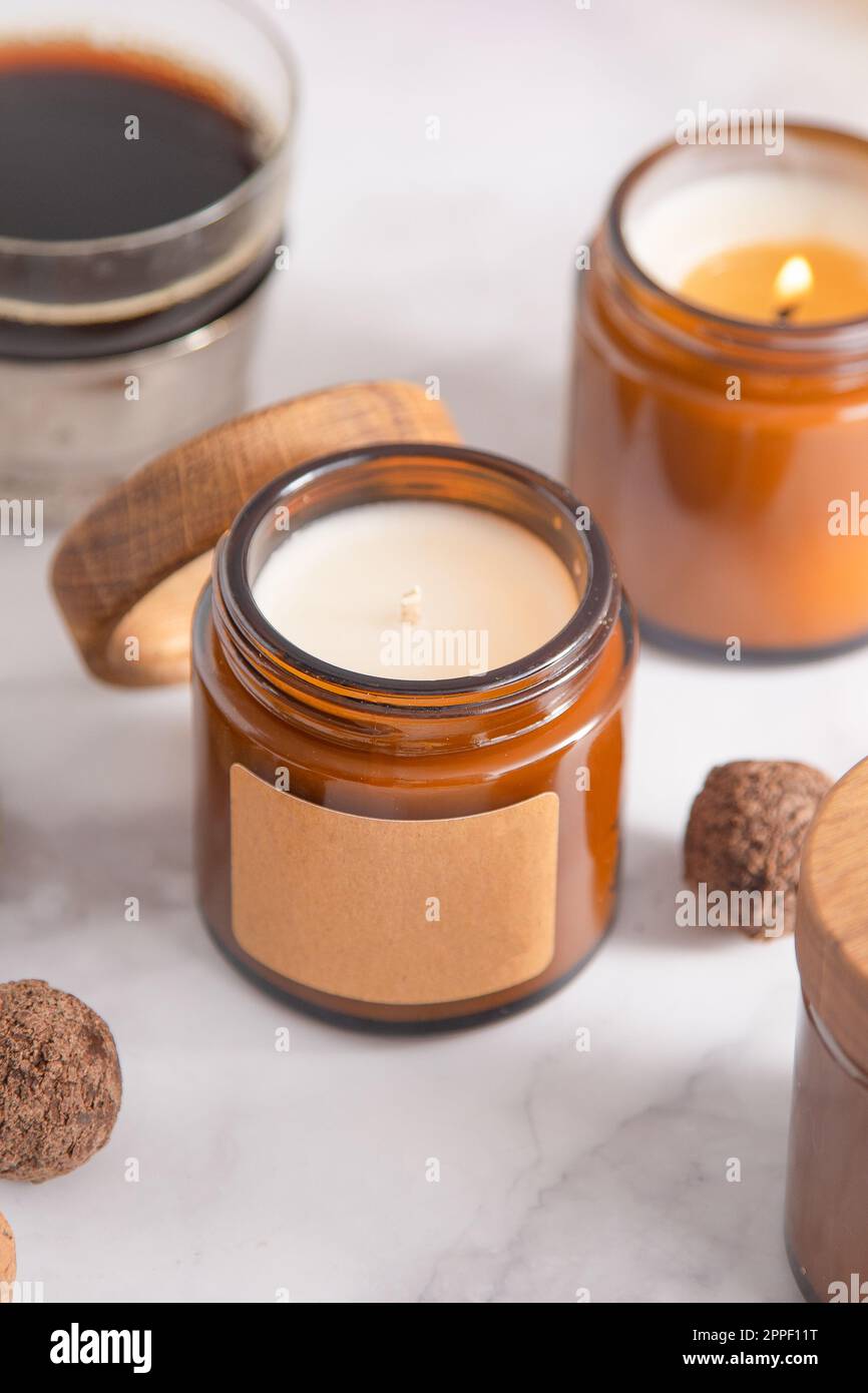 Soy aroma candle in a glass jar with a wooden lid. Copy space label ...