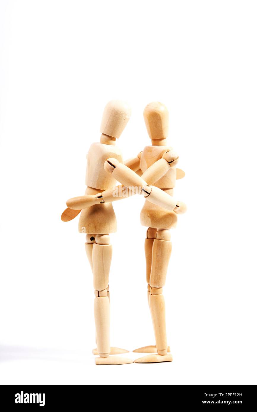 Two mannequins giving each other a hug on a white background. Concept of friendship and love Stock Photo