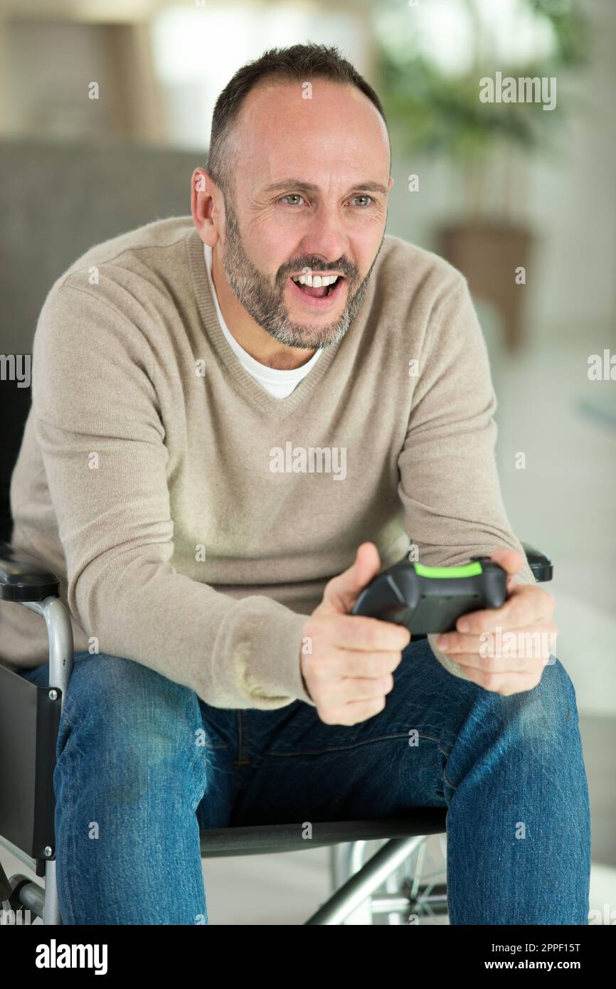 happy disabled man playing computer games during rehabilitation Stock Photo Alamy