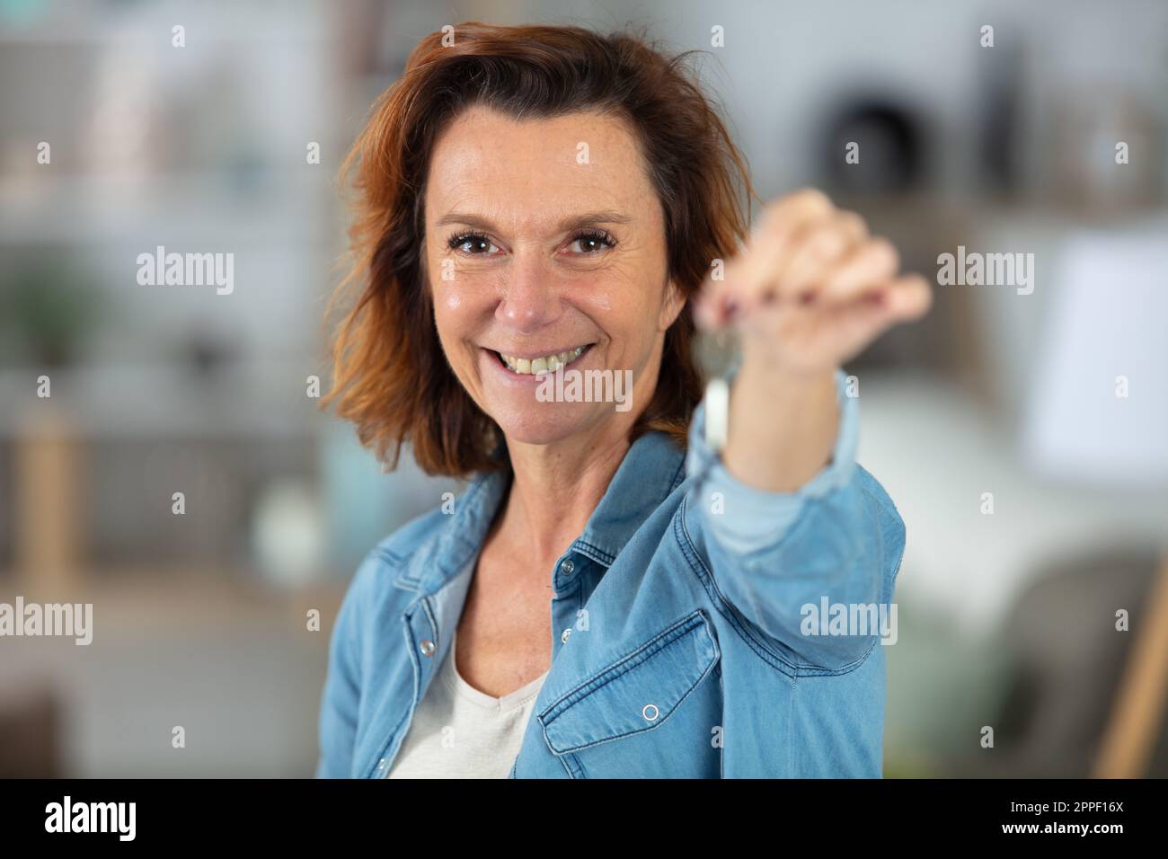 mature woman holding keys of her new house Stock Photo - Alamy