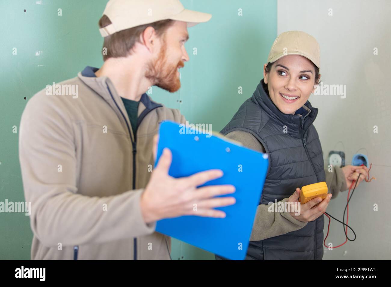electricians working at construction site Stock Photo
