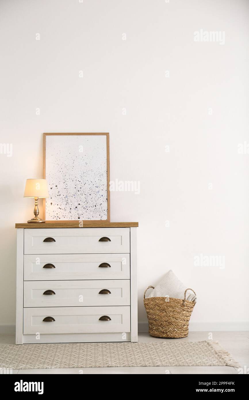 Stylish chest of drawers in living room interior Stock Photo