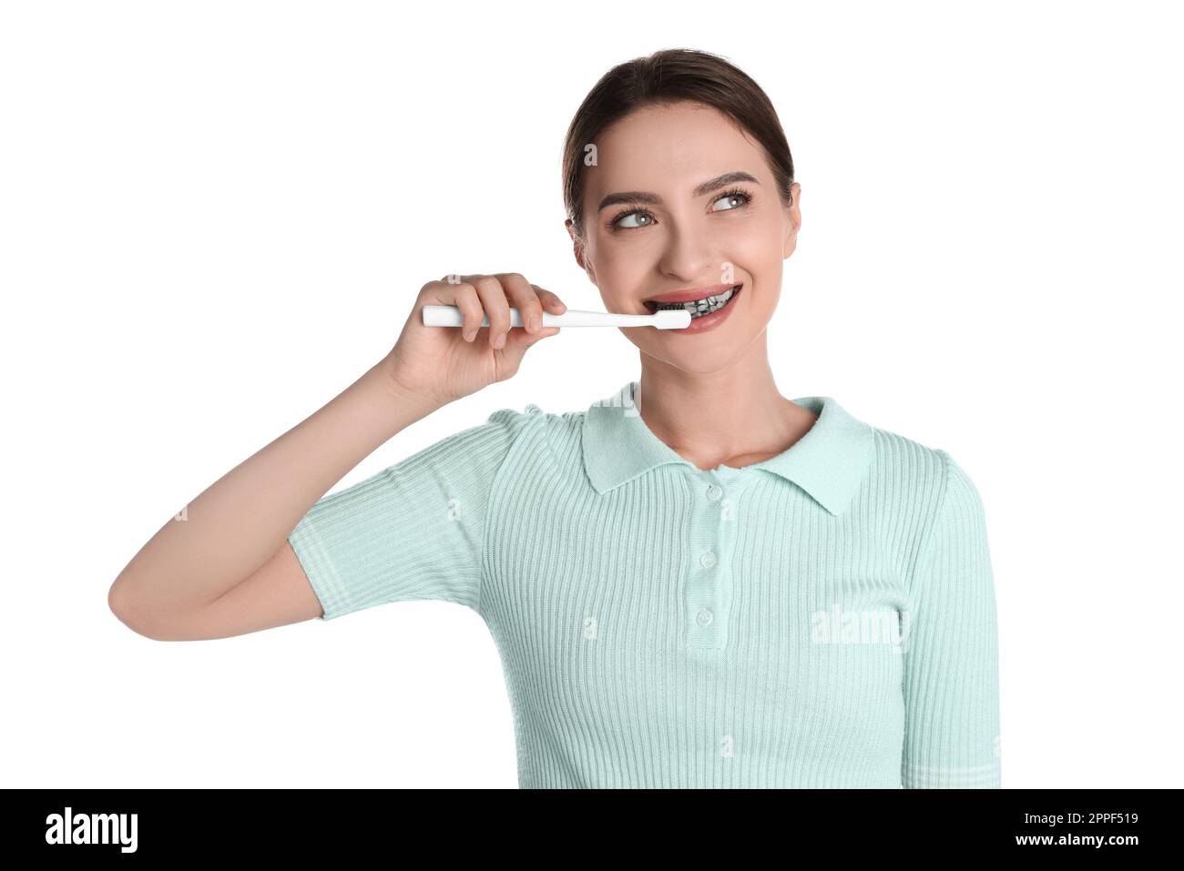 Young woman brushing teeth with charcoal toothpaste on white background Stock Photo Alamy