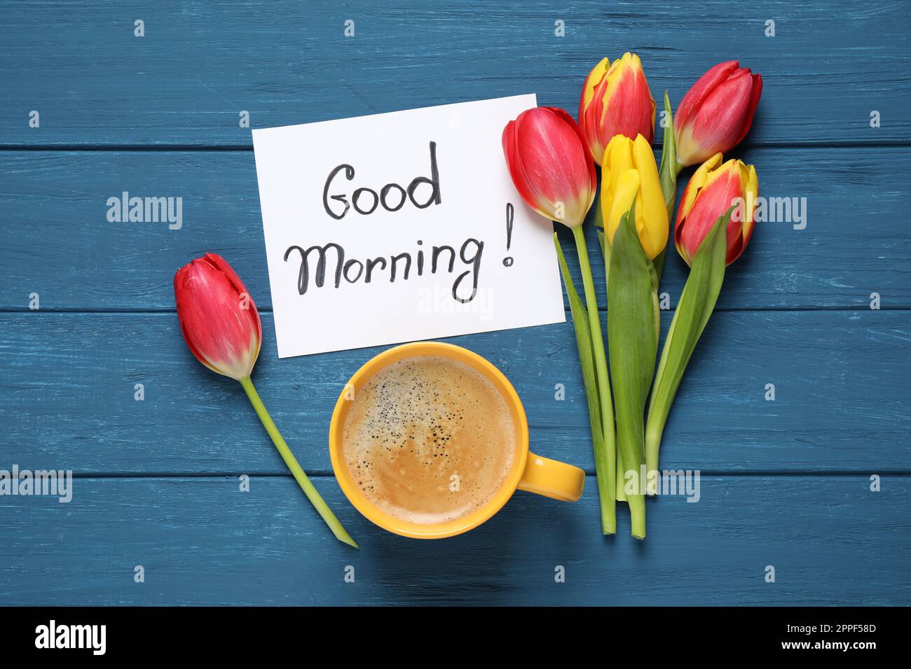 Message GOOD MORNING, tulips and coffee on blue wooden table, flat ...