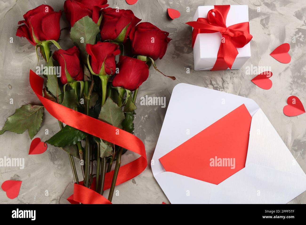 Flat Lay With Bouquet Of Roses Ribbon And Envelope Isolated On