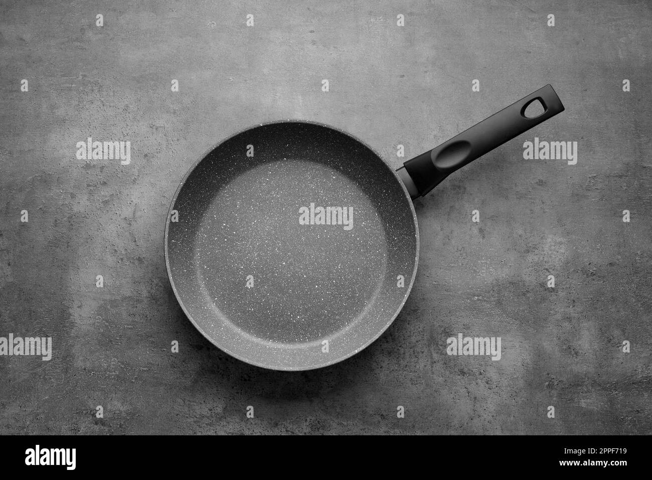 New non-stick frying pan on grey table, top view Stock Photo