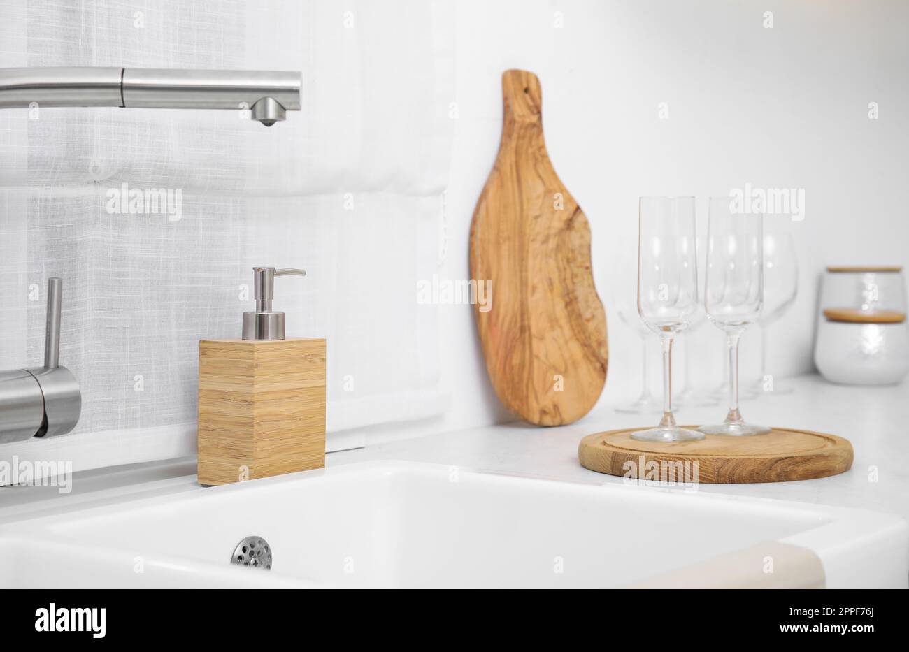 Kitchen counter with sink and clean glasses Stock Photo - Alamy
