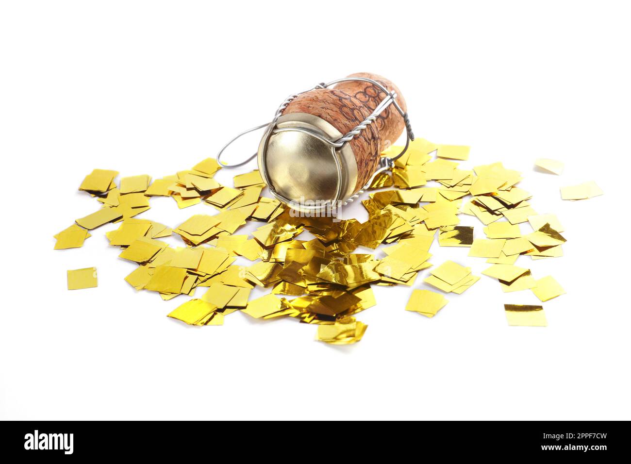 Cork of sparkling wine with muselet cap and shiny golden confetti on