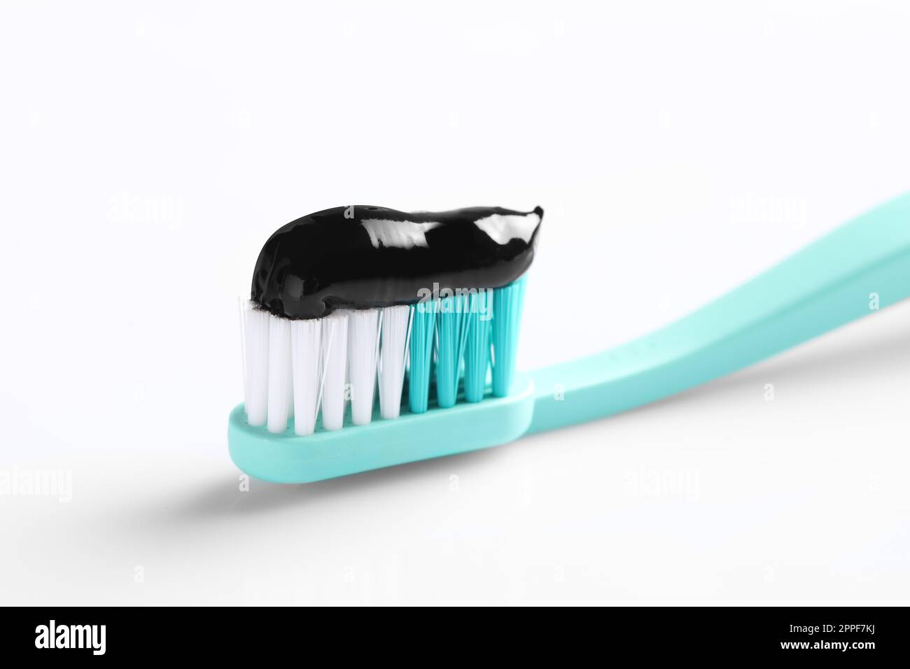 Brush with charcoal toothpaste on white background Stock Photo - Alamy