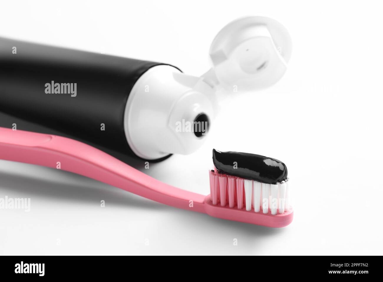 Brush with charcoal toothpaste on white background Stock Photo - Alamy