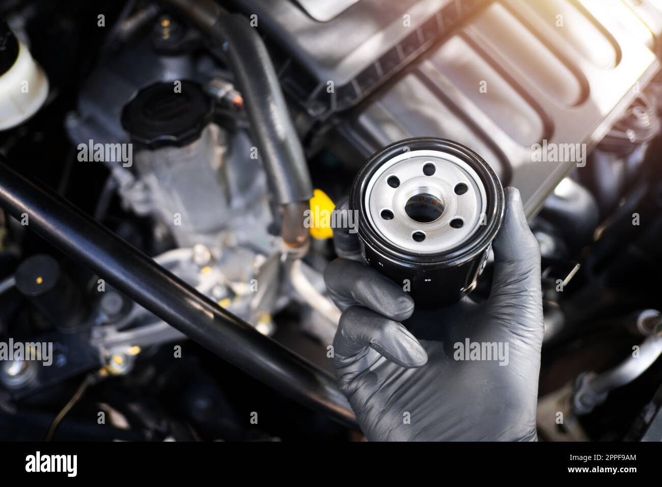 The new car oil filter, automotive spare part, car maintenance concept