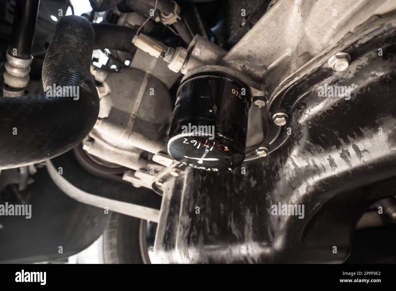 Oil leaking from motor oil filter, close up at an old oil filter. Car