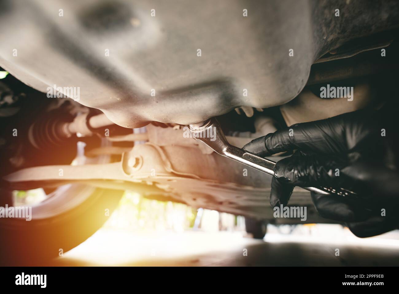 Technician loosen the drain plug with socket wrench. Car maintenance concept Stock Photo Alamy