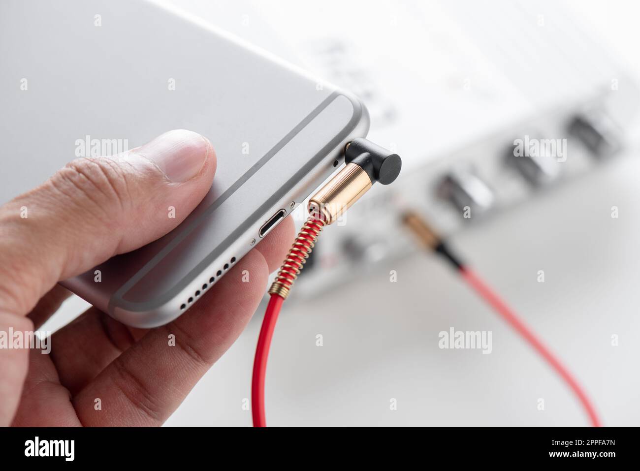 AUX cable connected between smartphone and mini amplifier. Cable for ...