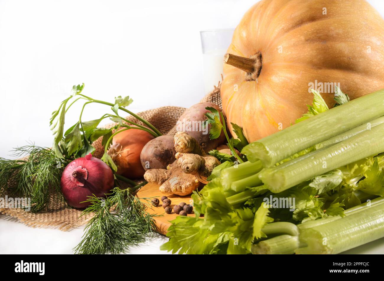 pumpkin, celery and other ingredients for pumpkin soup with breadcrumbs on a light background