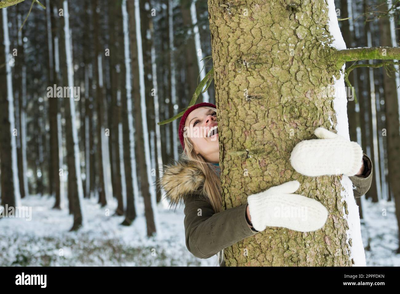 Teenage girl hugging a tree in a forest, Bavaria, Germany Stock Photo