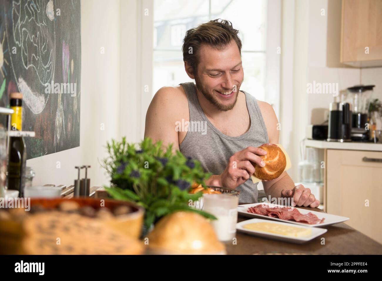 Man preparing breakfast in the kitchen, Munich, Bavaria, Germany Stock Photo