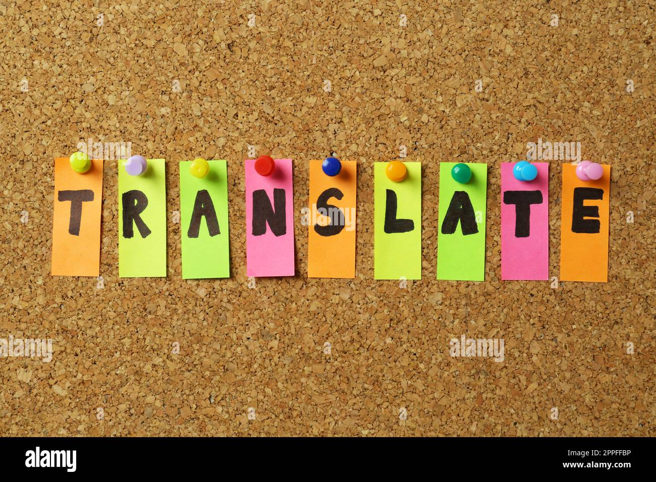 Word Translate made of stickers with letters pinned to cork board Stock