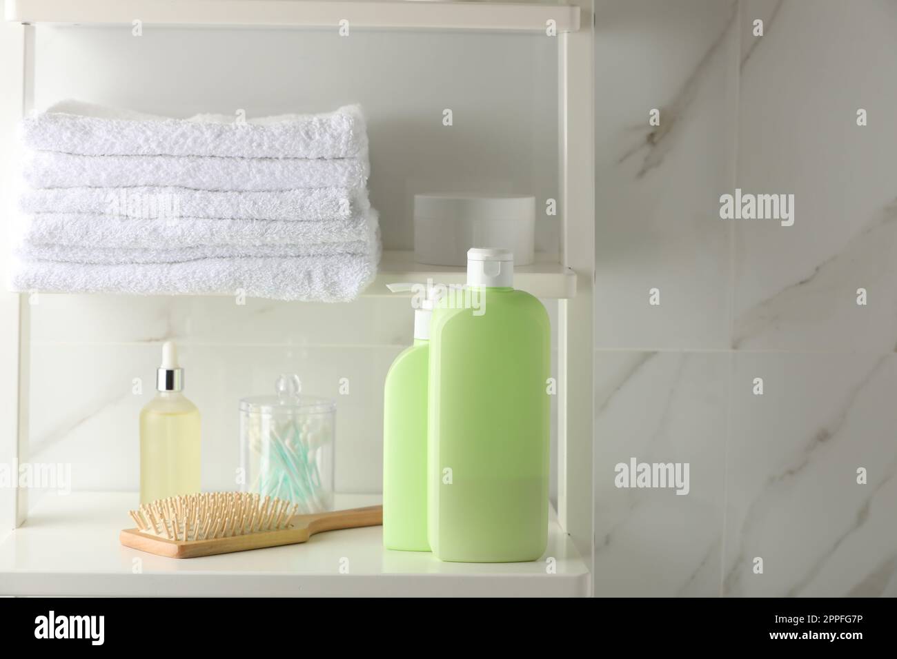 Stack Of Towels Hairbrush Shampoo And Other Toiletries On Shelves stack-of-towels-hairbrush-shampoo-and-other-toiletries-on-shelves