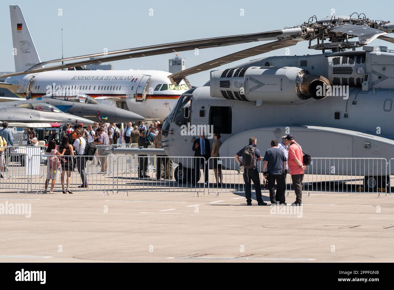 BERLIN, GERMANY - JUNE 23, 2022: Visitors to the exhibition on the airfield against the backdrop of various aircraft. Exhibition ILA Berlin Air Show 2022 Stock Photo