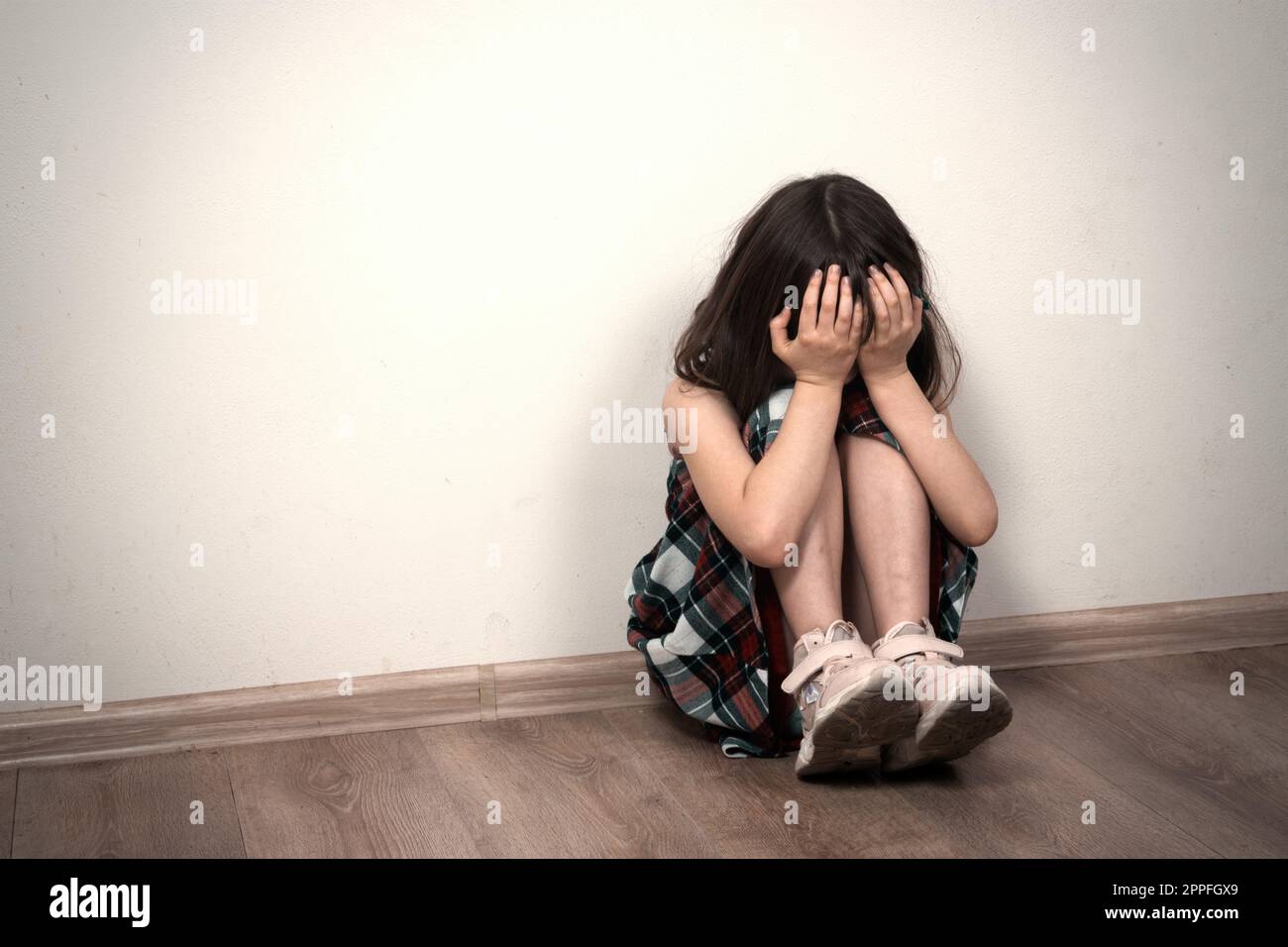 Small girl sitting in depression Stock Photo