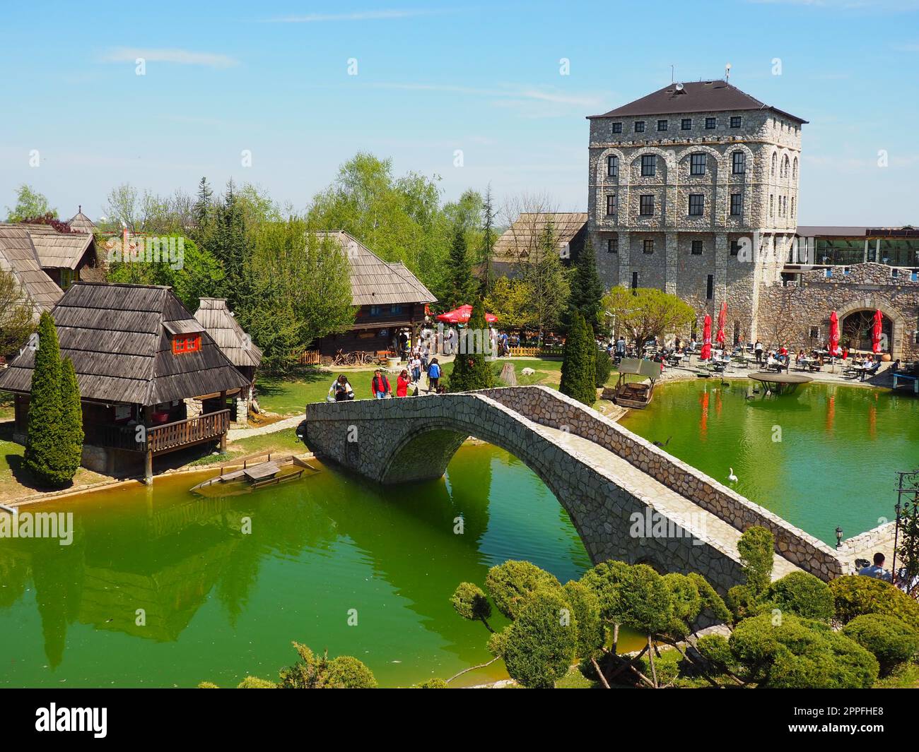 Stanisici, Bijelina, Republika Srpska, Bosnia and Herzegovina April25 2021 Ethno village, tourism and attractions. Stone and wooden buildings of the hotel. People visit restaurant, traditional houses Stock Photo