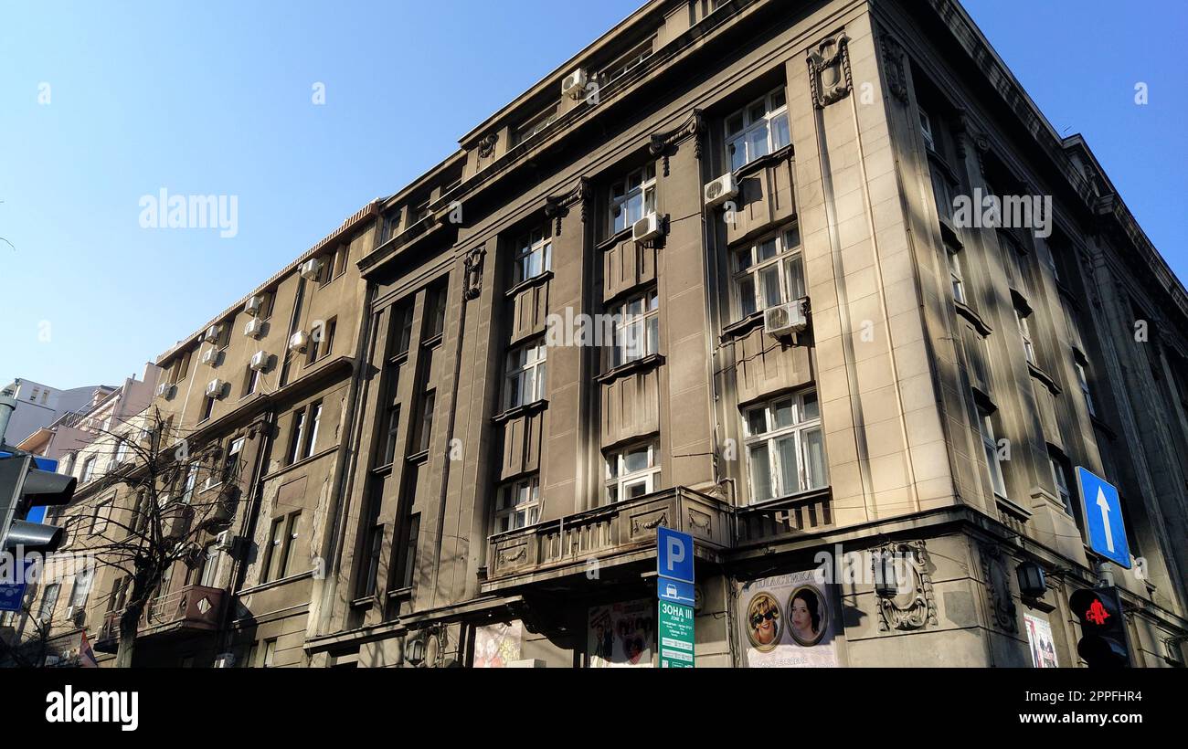 Belgrade, Serbia - January 24, 2020. Street view of an old monumental building. Facade in dark gray tones. Early morning in good weather Stock Photo