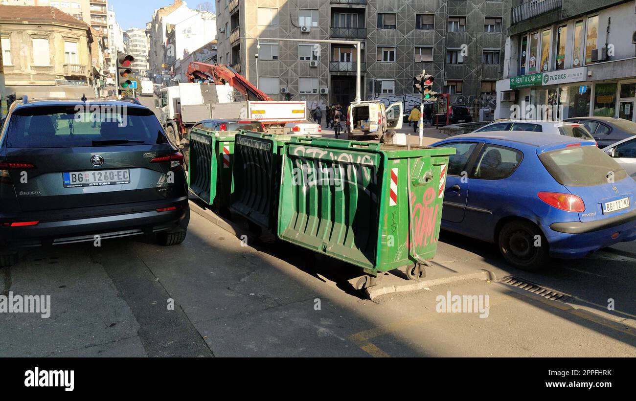 Belgrade, Serbia. January 24, 2020. Garbage containers in the city center. Roadway with cars. Asphalt road with passers-by. An editorial shot of Balkansk street. Stock Photo