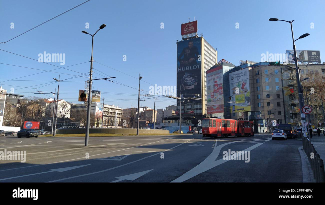 Belgrade, Serbia. March 20, 2020. Slavia Square. Central circular area with active traffic. The famous hotel Slavia. Buildings, promising vehicles and streetlights. Sunny weather Stock Photo