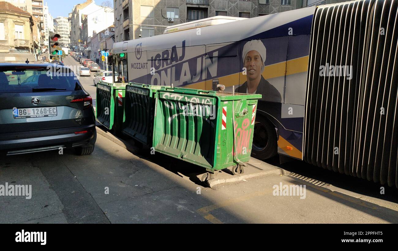 Belgrade, Serbia. January 24, 2020. Garbage containers in the city center. Roadway with cars. Asphalt road with passers-by. An editorial shot of Balkanska street. Accordion bus Stock Photo