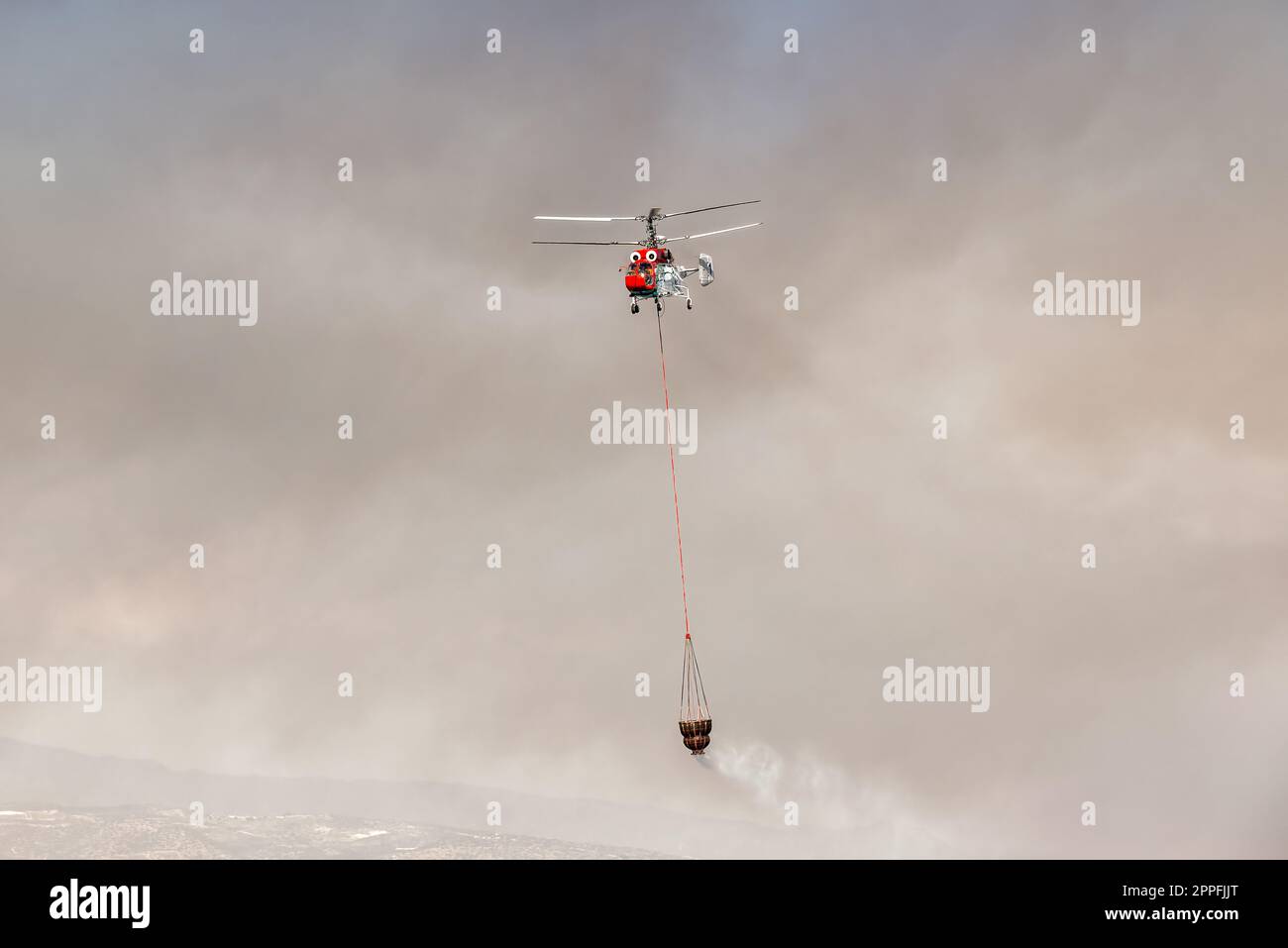 Firefighter helicopter with water bucket Stock Photo Alamy