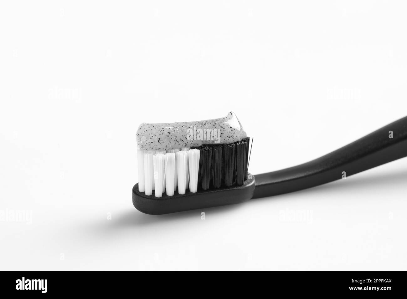 Brush with charcoal toothpaste on white background Stock Photo - Alamy