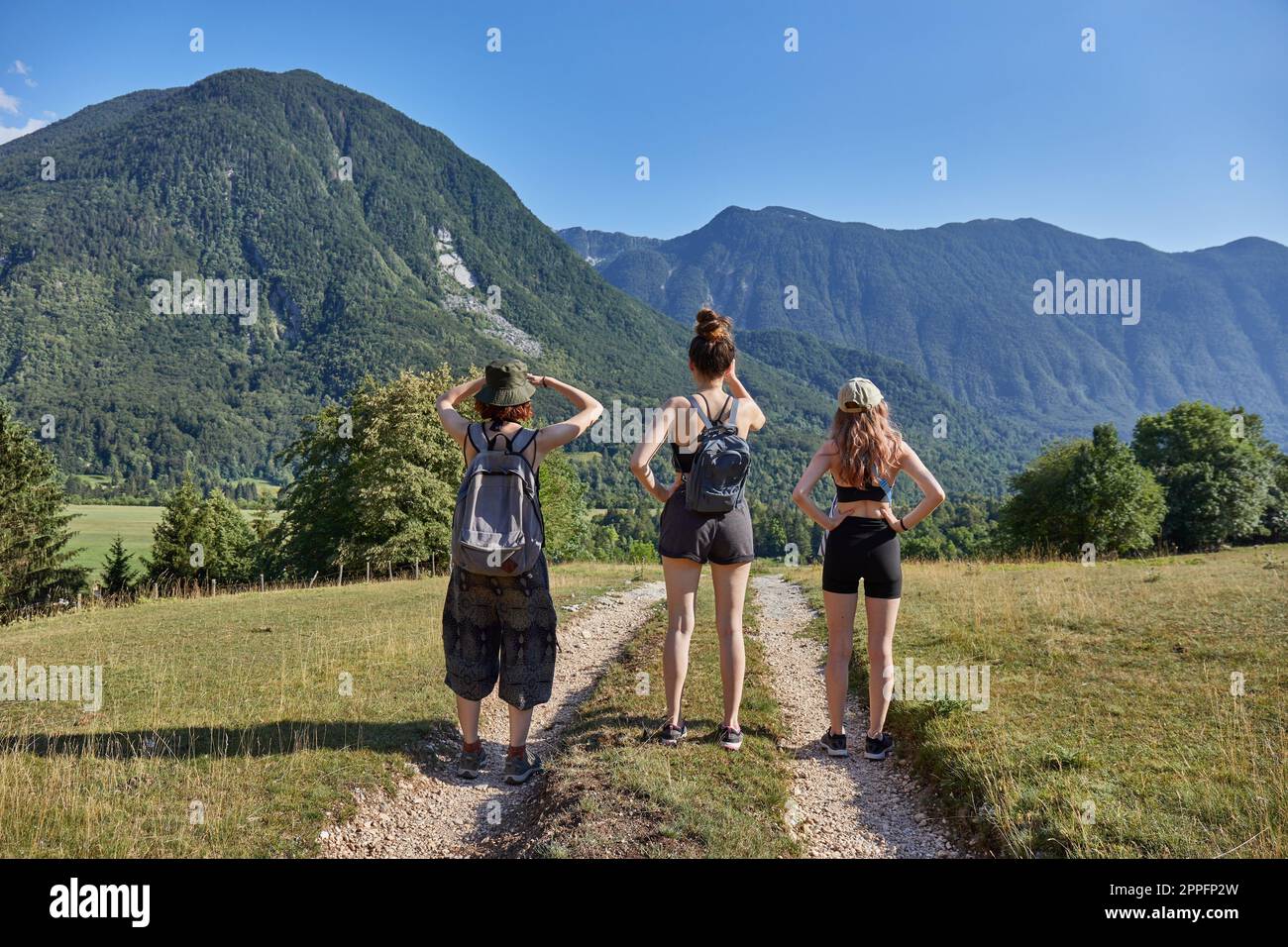 Girls hiking in the Alps, summer mountain landscape Stock Photo