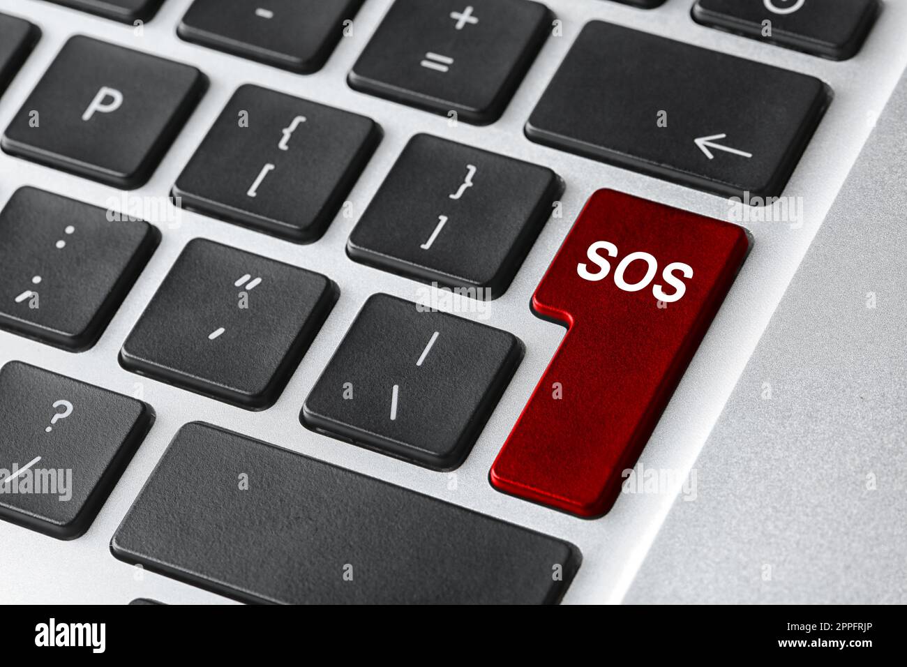 Red button with word SOS on computer keyboard, closeup. Rescue concept Stock Photo