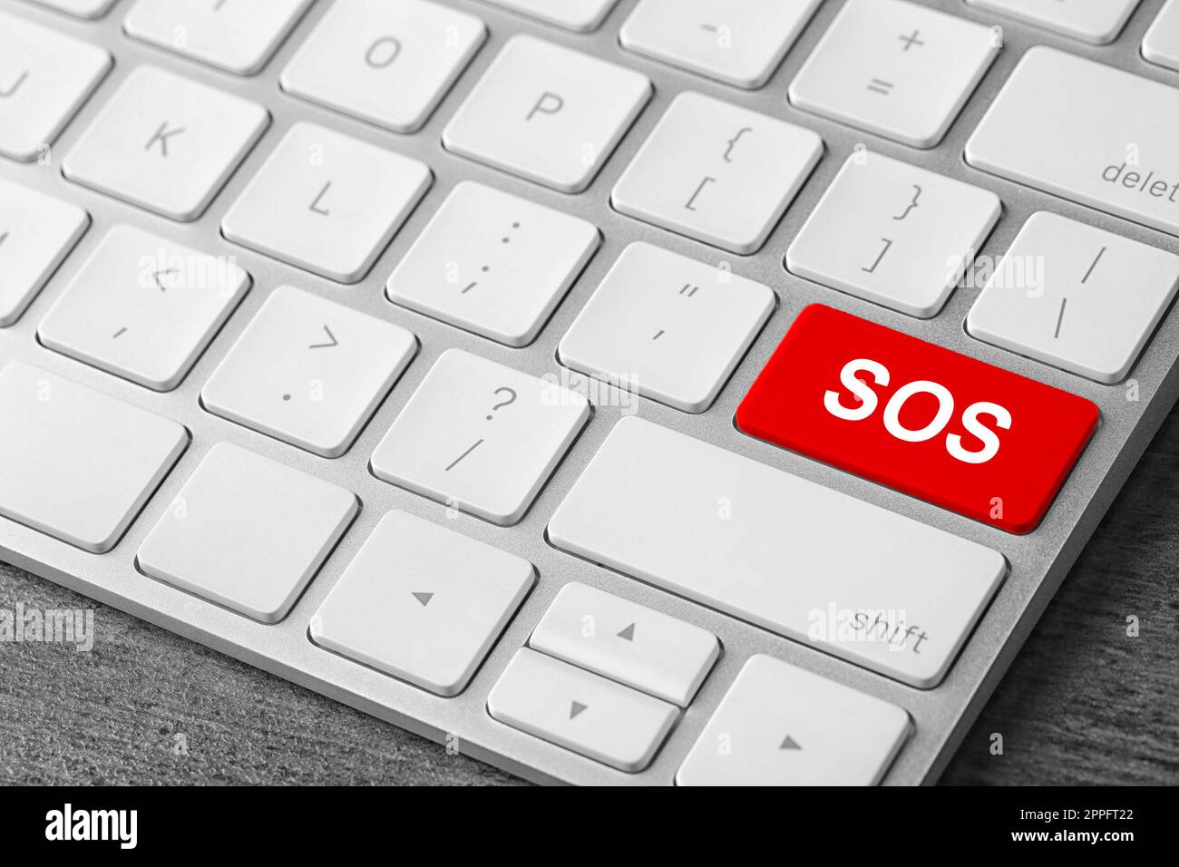 Red button with word SOS on computer keyboard, closeup. Rescue concept Stock Photo