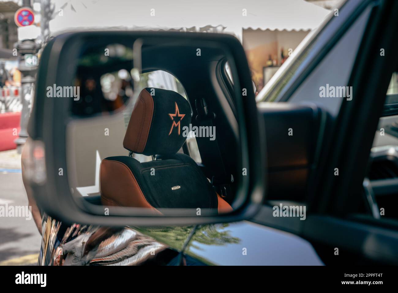 BERLIN - JUNE 18, 2022: Fragment of Interior of full-size pickup truck Militem Magnum on based by Dodge RAM 1500 in the reflection of rear view mirror. Classic Days Berlin. Stock Photo