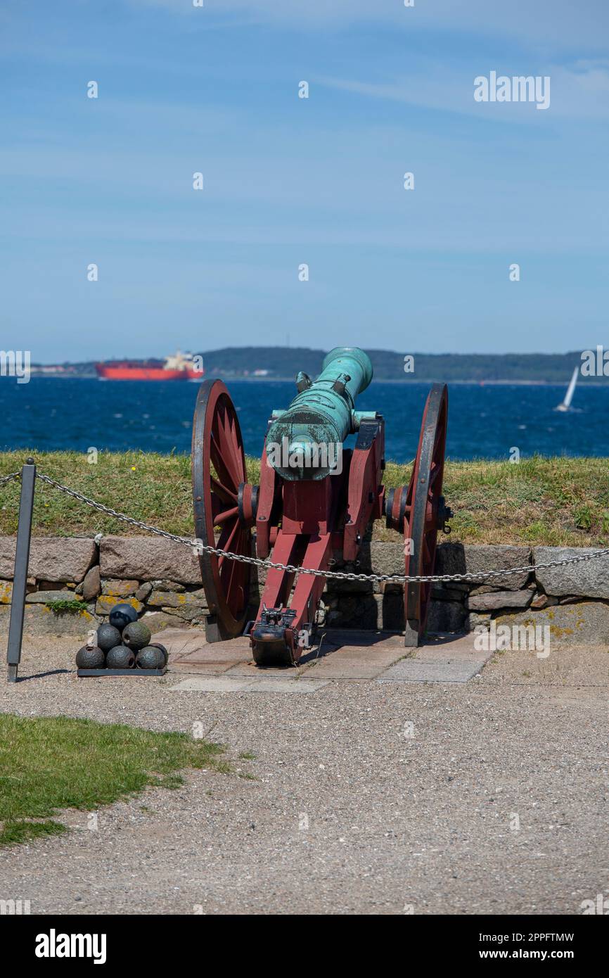 Cannon in front of medieval Kronborg Castle on the Baltic Sea over the Oresund Strait, Helsingor, Denmark Stock Photo