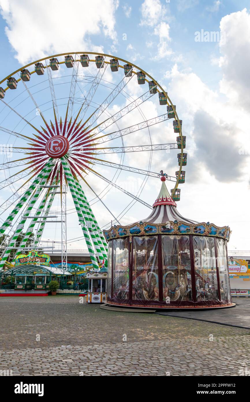 DÃ¼sseldorf, NRW, Germany - 07 14 2022: Big ferris wheel with Fortuna 95 logo as thrilling fun ride on the DÃ¼sseldorfer Rheinkirmes amusement park as big parish fair and kermis Germany for F95 fans Stock Photo