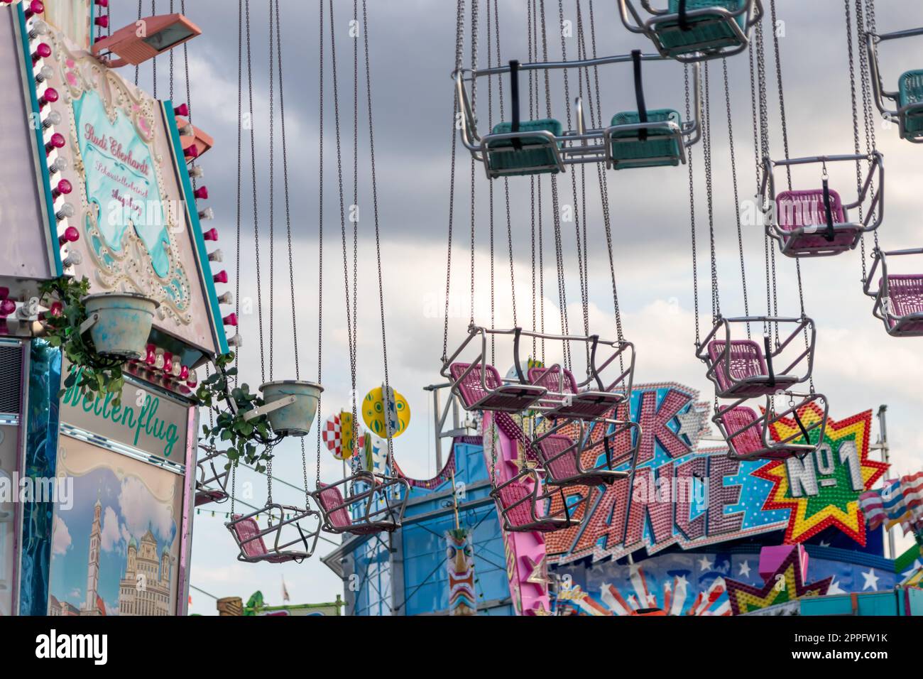 DÃ¼sseldorf, NRW, Germany - 07 14 2022: chairoplane and chain carousel waiting for guests on the Dusseldorfer Rheinkirmes amusement park as big parish fair and kermis in Germany for fun and whirligig Stock Photo