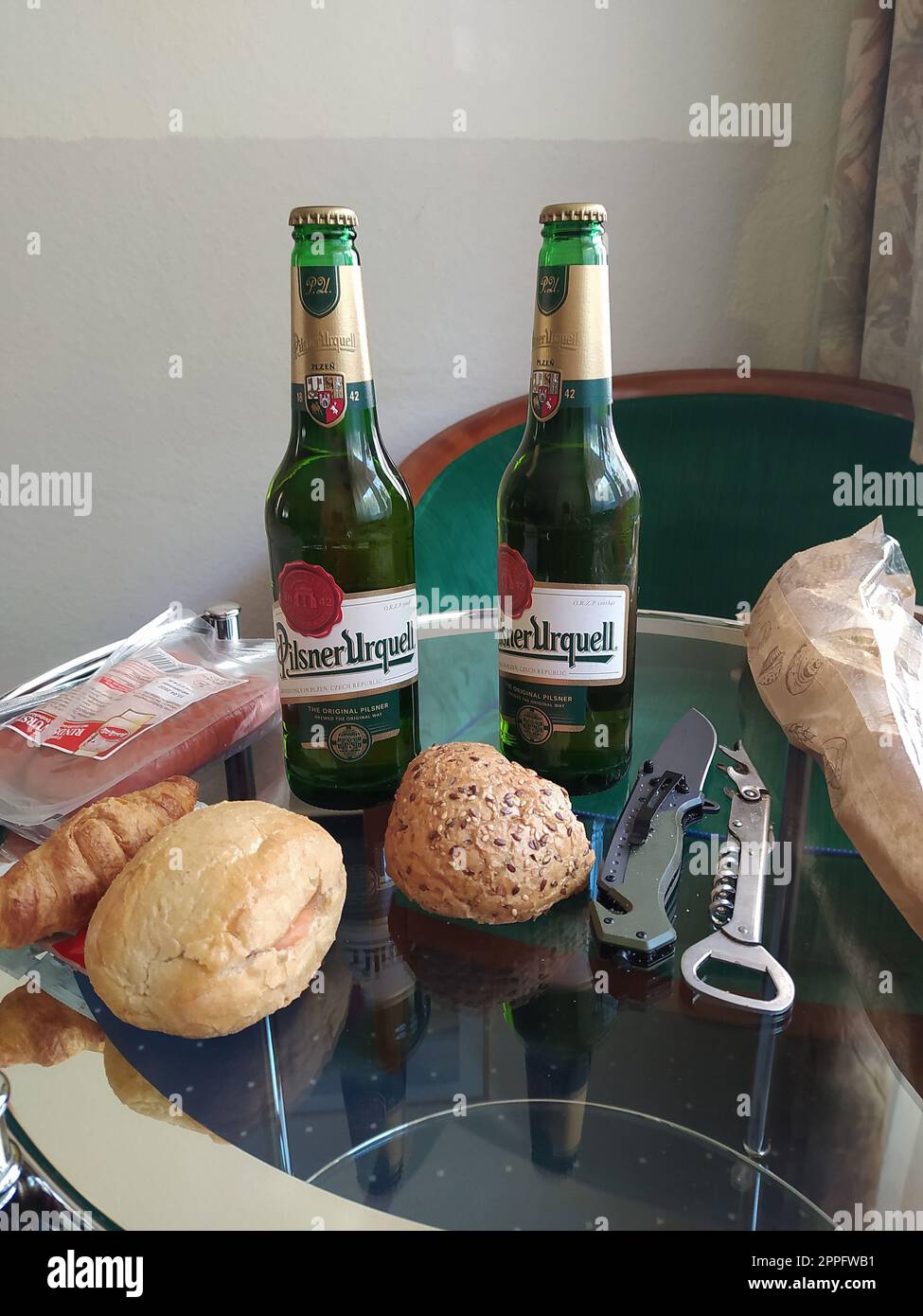 2 bottles of Pilsner Urquell beer on a table to have a dinner in Prague, Czech Stock Photo