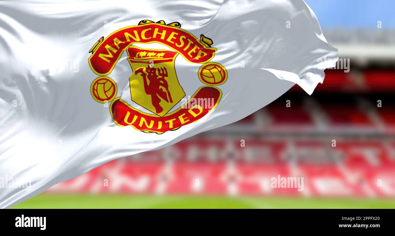 Manchester, UK, May 2022 The flag of Manchester United waving with Old