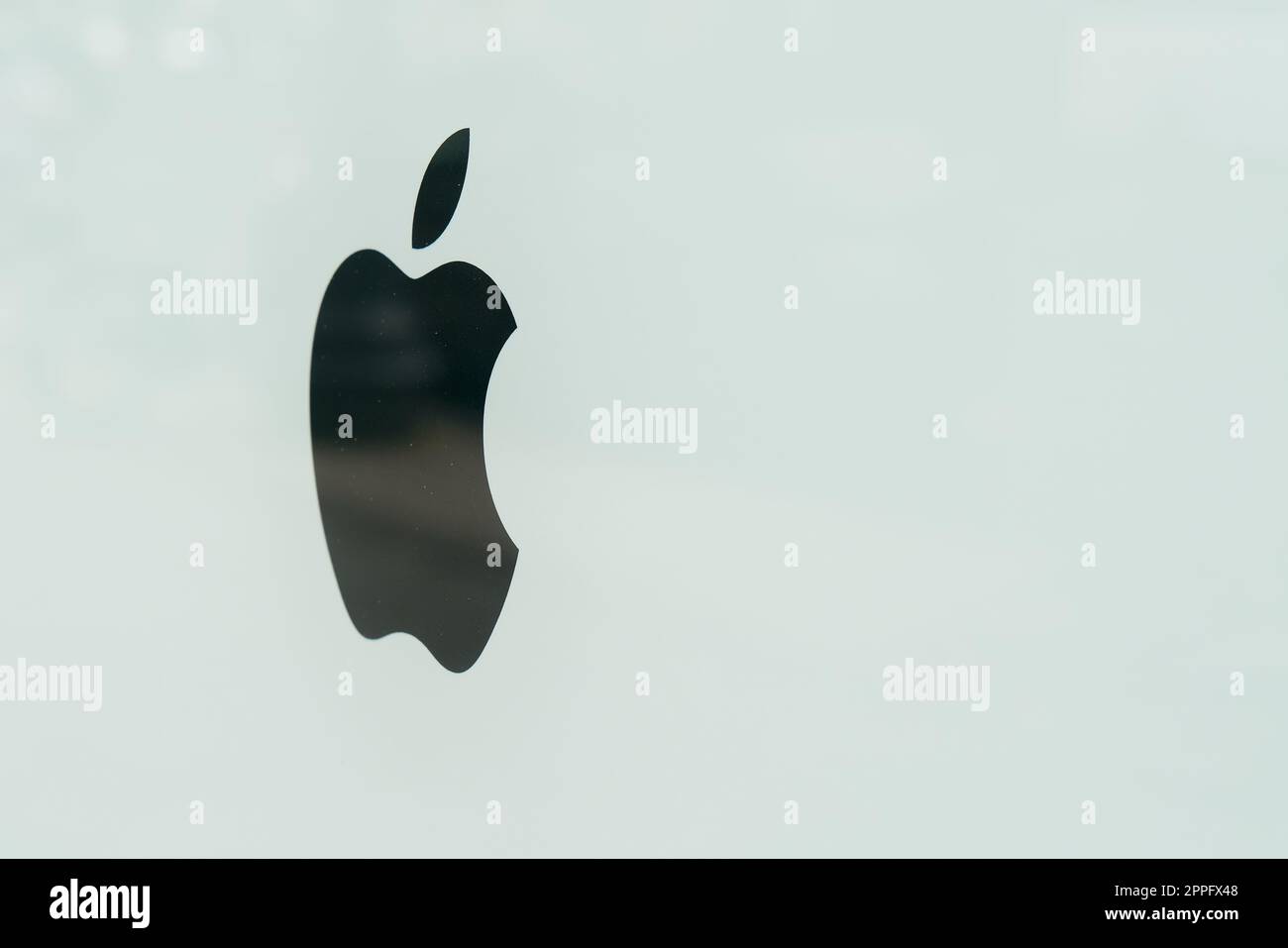 Logo of Apple company on a dirty shop window in downtown Berlin Stock Photo