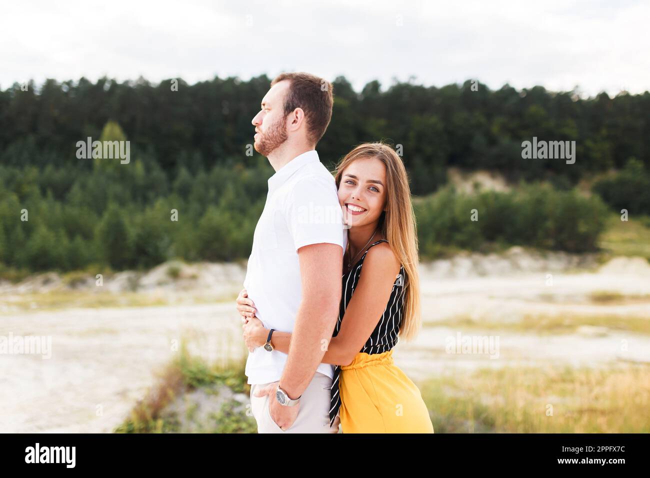 man and a woman are hugging on a sandy beach in summer Stock Photo - Alamy